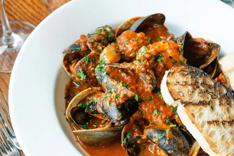 P.E.I. mussels and clams in tomato confit sauce with grilled crostini